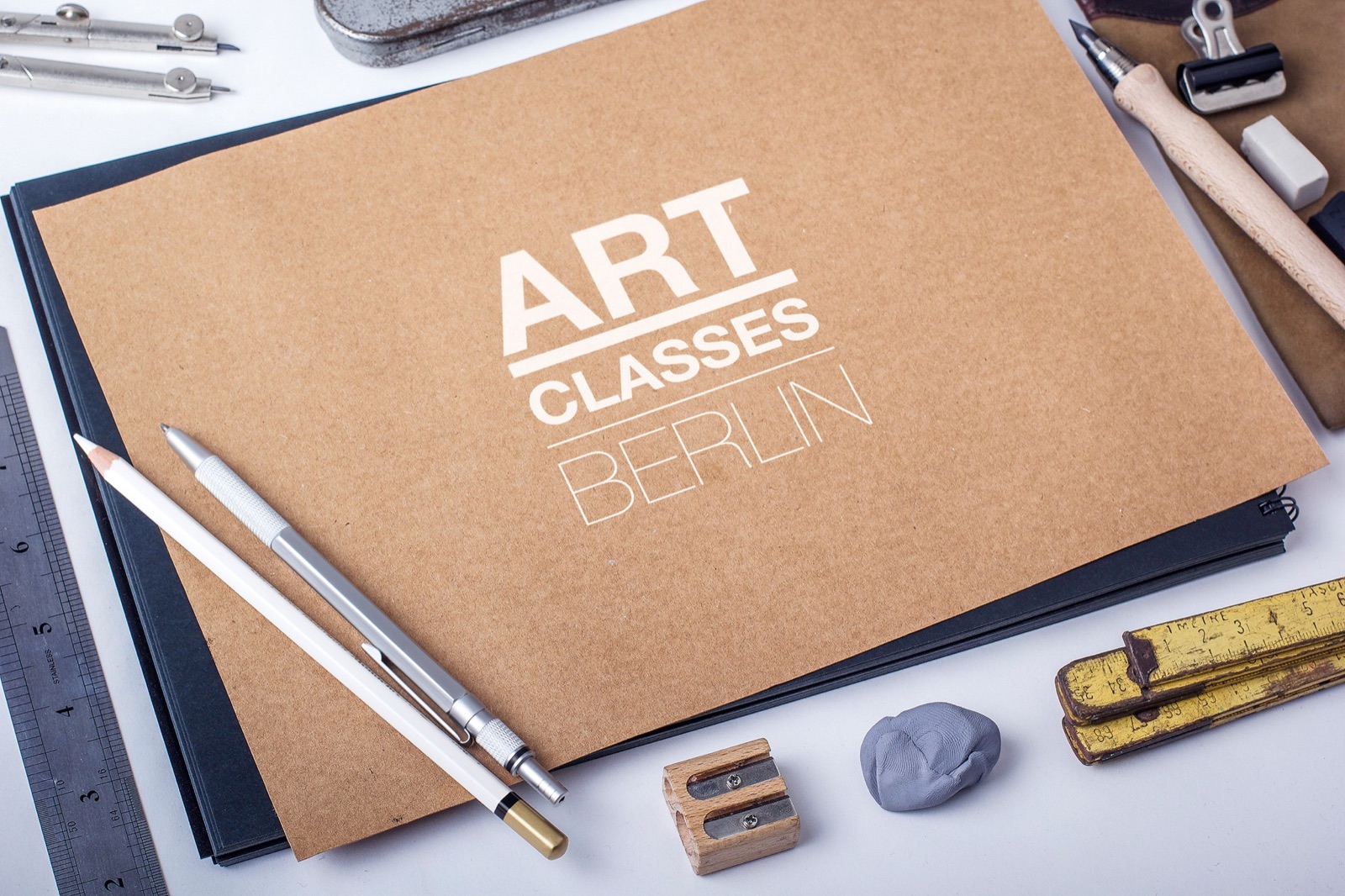 Art Classes Berlin sketchbook surrounded by drawing materials