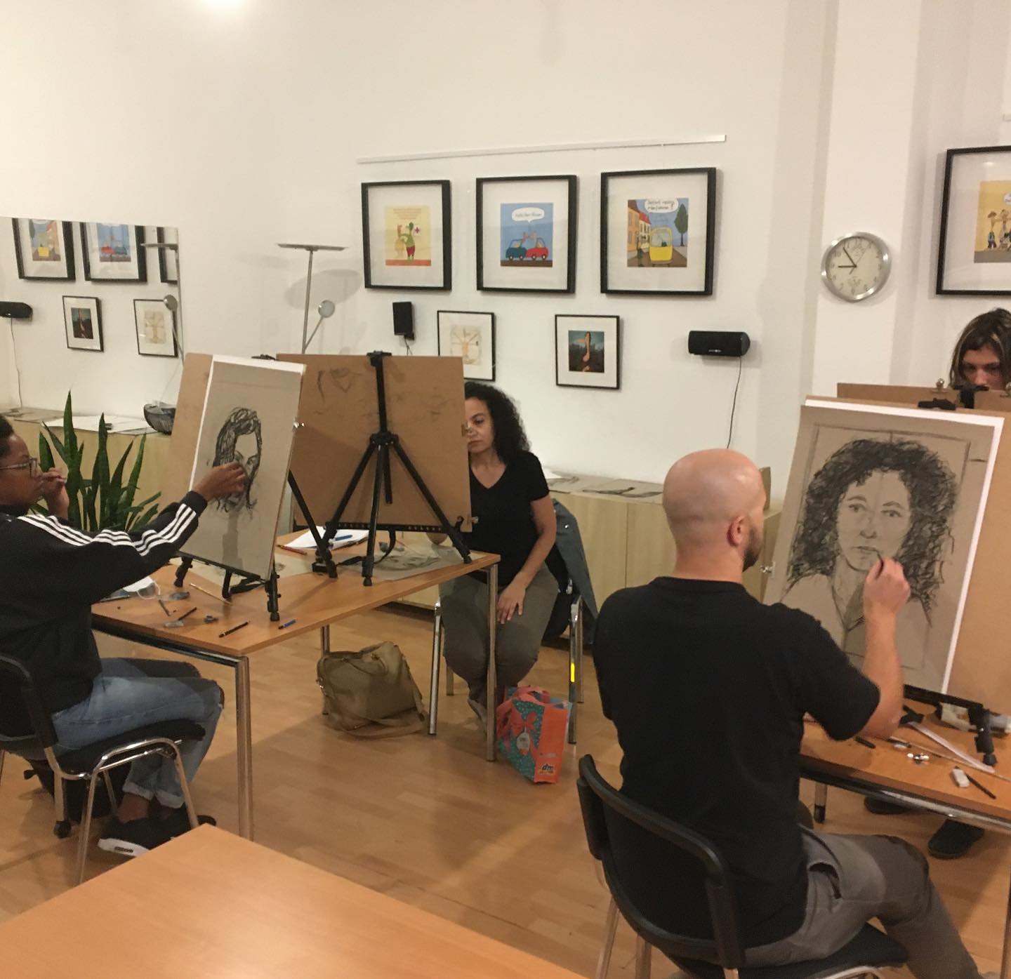 Adults drawing portraits in a small Art Classes Berlin workshop
